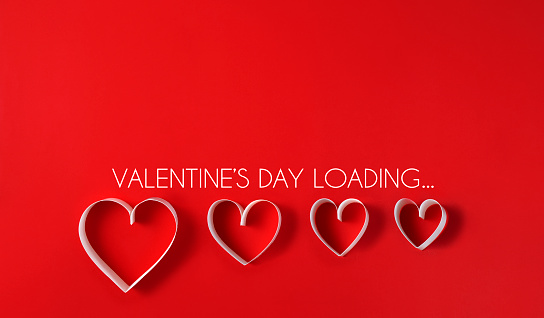 Loading process with hearts for Valentine’s Day concept on a red background