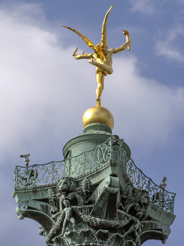 Paris , France 09-29-2009 Place de la Bastille, the July Column against a blue sky with white clouds in Paris, France.