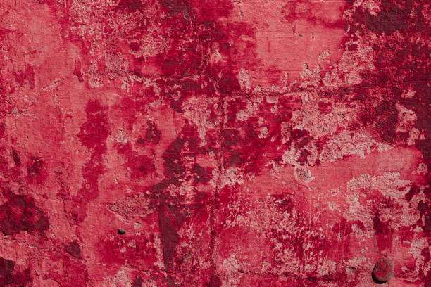 istock Red concrete wall with deep scratches and chips. Various variations of abrasions. 1909383641
