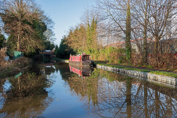 istock Narrowboat on a British canal in rural setting 1909389393