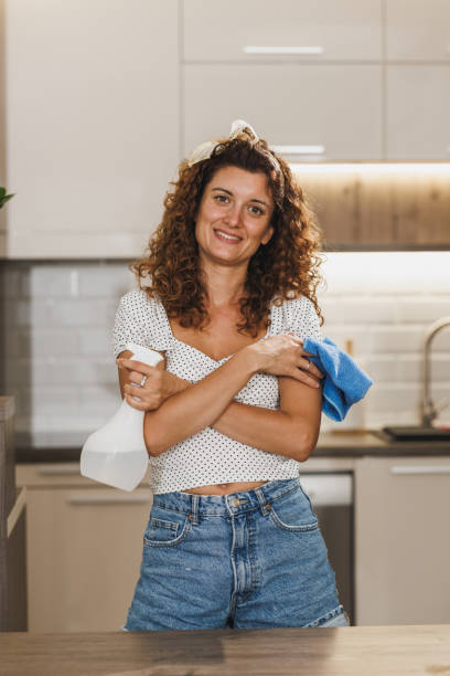 istock A Woman Standing In A Kitchen With A Rag 1909392019