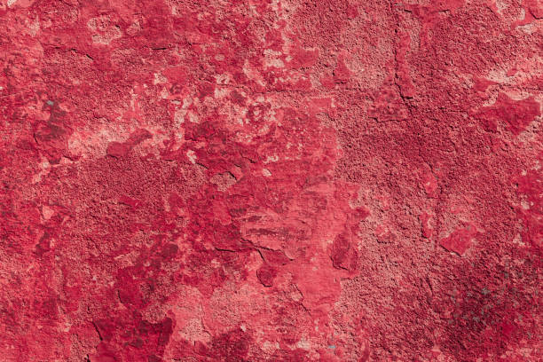 istock Red concrete wall with deep scratches and chips. Various variations of abrasions. 1909394580