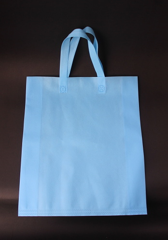 A simple plain blue carrying bag made from spunbond material photo