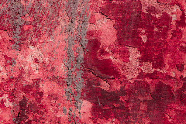 istock Red concrete wall with deep scratches and chips. Various variations of abrasions. 1909404497