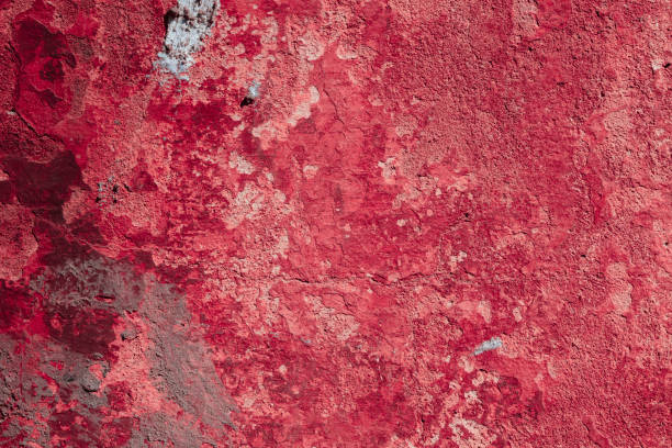 istock Red concrete wall with deep scratches and chips. Various variations of abrasions. 1909409831