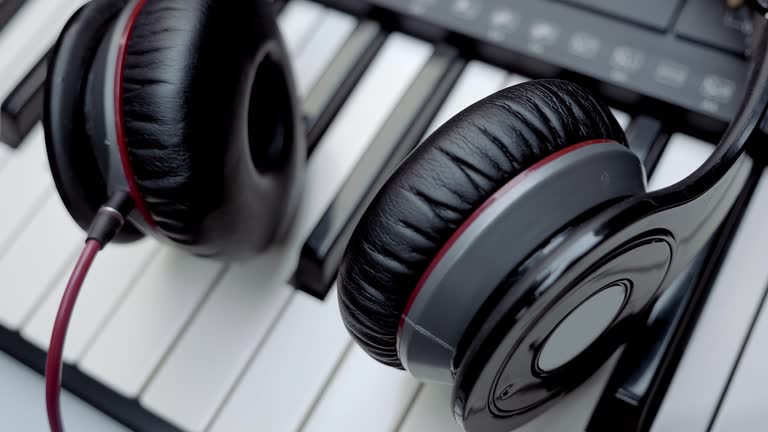 A DJ (musician)'s headphones are on the synthesizer (piano) keyboard