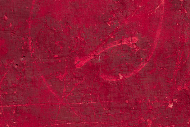 istock Red concrete wall with deep scratches and chips. Various variations of abrasions. 1909421399