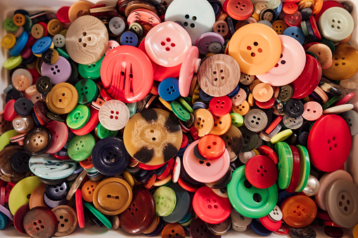 A close-up of a collection of multi-coloured buttons.