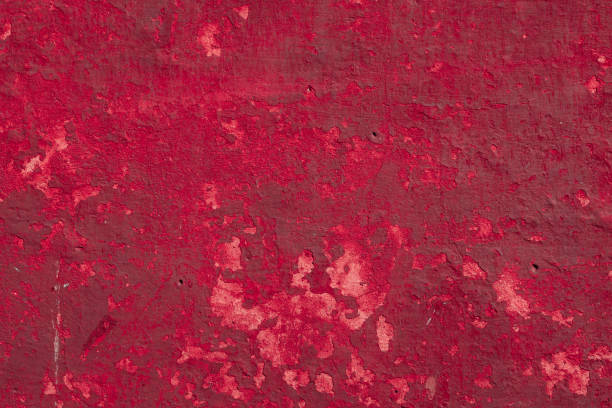 istock Red concrete wall with deep scratches and chips. Various variations of abrasions. 1909435577