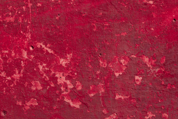 istock Red concrete wall with deep scratches and chips. Various variations of abrasions. 1909437635