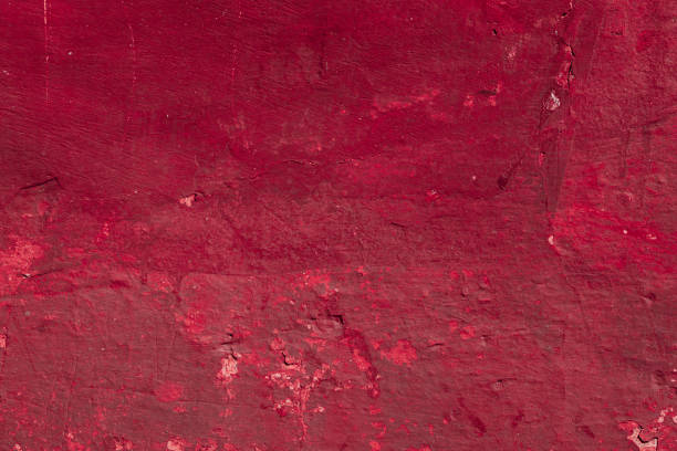 istock Red concrete wall with deep scratches and chips. Various variations of abrasions. 1909442975