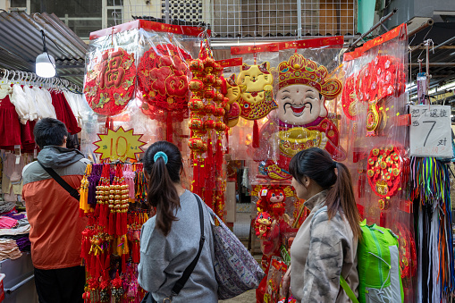 Hong Kong - January 5, 2024 : People select new year decorations at street market ahead of Chinese New Year in Hong Kong.