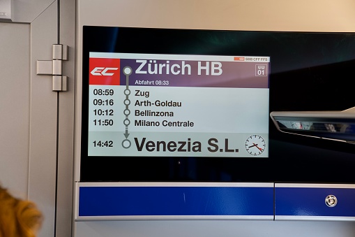 Screen inside of SBB CFF FFS Eurocity train with terminal destination Venice Italy at railway main station at City of Zürich on a cloudy summer morning. Photo taken August 6th, Zurich, Switzerland.