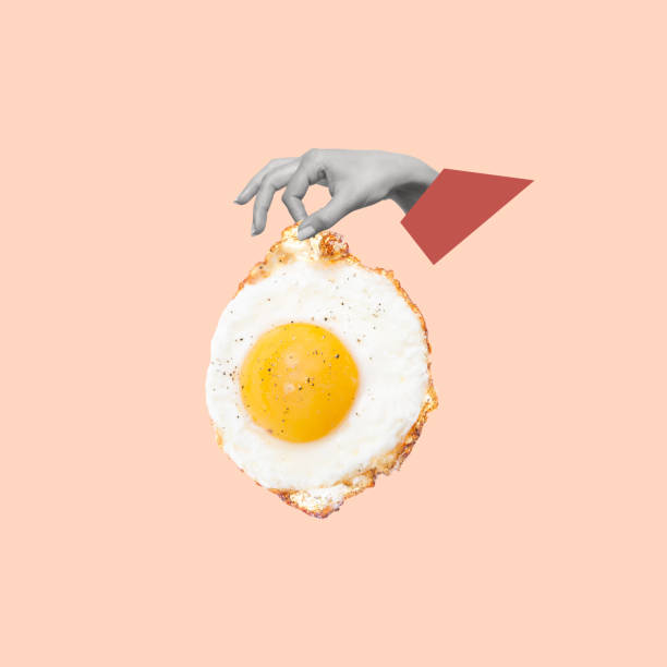 istock Contemporary art collage of hand holding fried egg. 1909477251