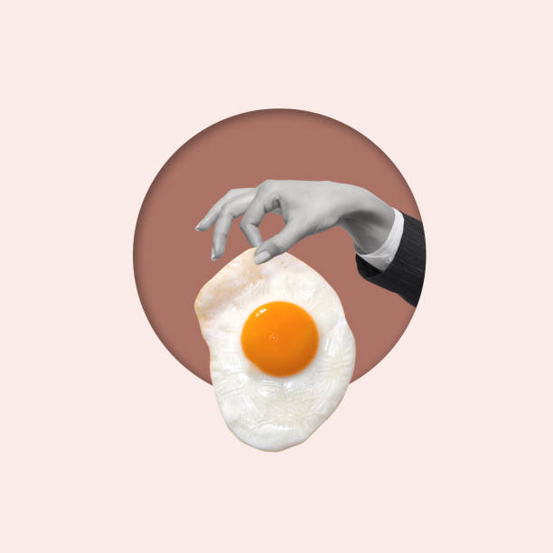istock Contemporary art collage of hand holding fried egg. 1909477255