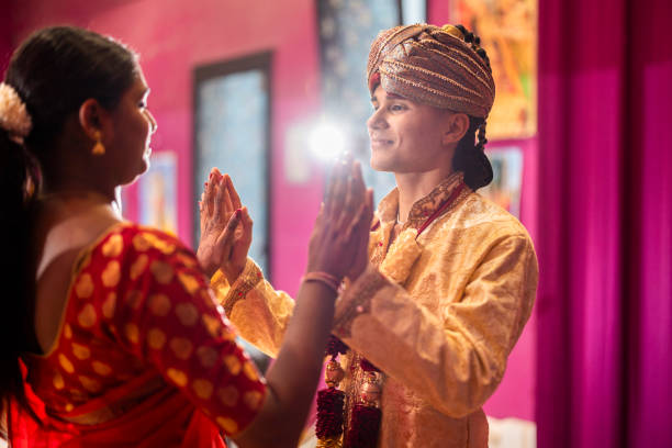 istock young hindu couple join hands for indian ceremony with backlight 1909484168
