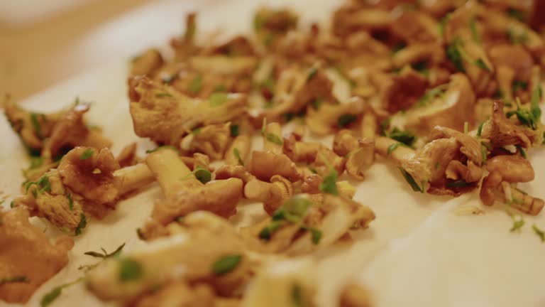 Close up of mashrooms with green salat vegetables on wood kitchen surface