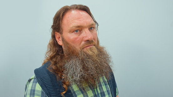 Man with a red beard and long hair shot close-up