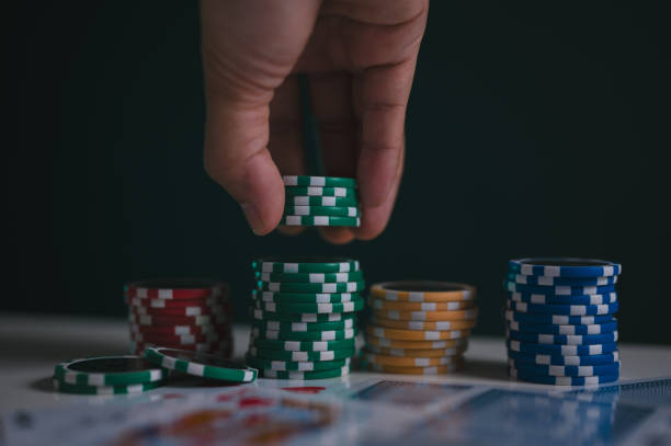 istock a man or poker player stack chips on table in concept of casino gambling all in 1909536025