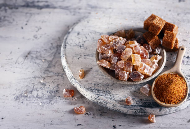 istock brown organic cane sugar on wooden background 1909542416