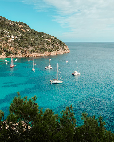 A scenic view of boats in the sea at Cala Vadella, Ibiza, Spain