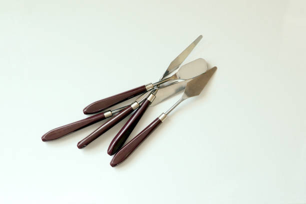 istock Set of different palette knives on a canvas background 1909580415