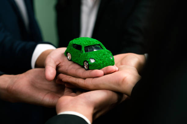 istock Business people synergy holding EV car model. Quaint 1909580966