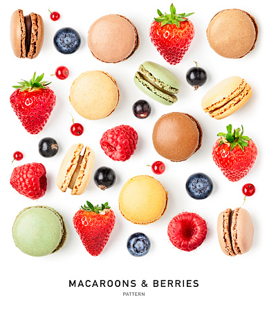 Macaroons, strawberry, raspberry, currant and blueberry berries pattern isolated on white background. Holiday greeting card. Springtime. Design element. Creative layout. Flat lay, top view