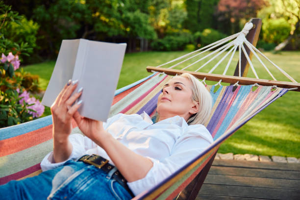 Free Stock Photo of Woman Relaxing in Hammock While Reading Book ...