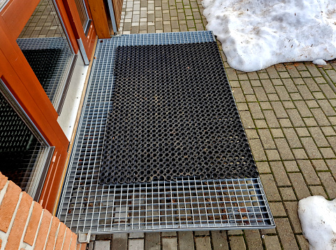 staircases made of steel gratings with rubber anti-slip mats. the mat at the cottage is on a raised staircase, snow removal from ski boots is much easier. winter surroundings of a mountain hut