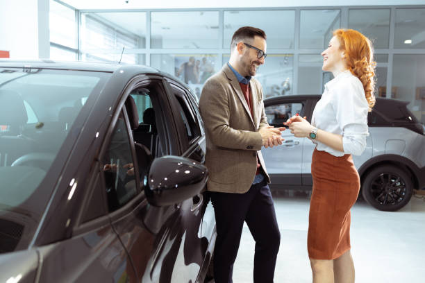 istock Couple visiting car dealership 1909625693