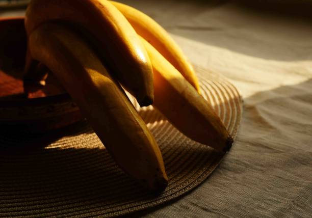 istock Close up banana branch with shadow. 1909640404