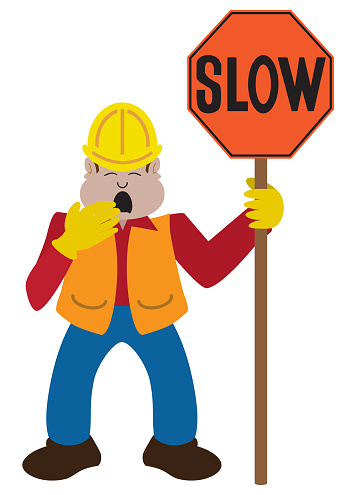 A bored construction worker with a sign is stifling a yawn