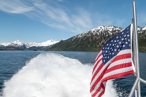 American Stars and Stripes flag on the back of a boat in Prince William Sound, Alaska, USA