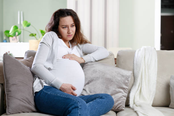 istock Young woman suffering from nausea and headache during pregnancy 1909715567