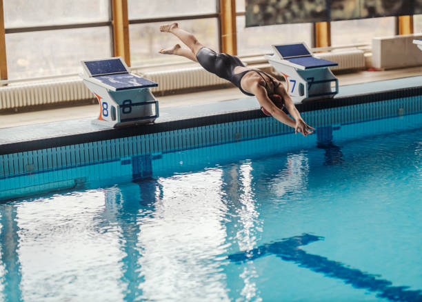 istock A professional female swimmer is diving into the pool. 1909715594