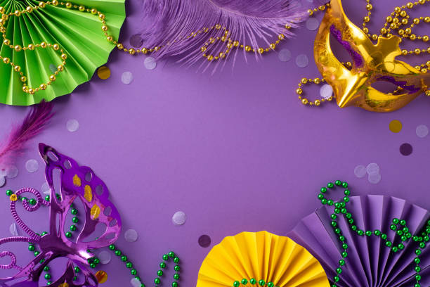 istock Extravaganza Elegance: top view luxe Venice masks, festive beads, feathers, confetti, radiant paper fans create a dazzling display on a regal purple surface, offering an ideal canvas for your message 1909720881