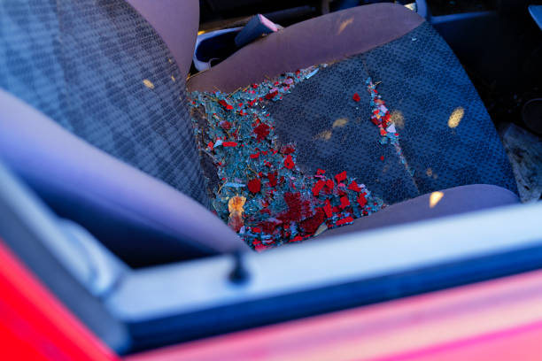 Red Vehicle with Broken Shattered Glass on Seat stock photo