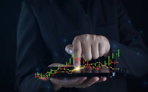 istock Businessman with mobile stock trading graph ,hands using mobile phone. 1909740181