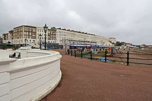 Herne Bay, Kent, United Kingdom, December 29, 2023. Holiday resort town seafront promenade, beach and buildings exterior. Overcast winter day outdoors.