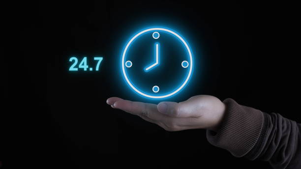 istock Customer service, businessman hands holding virtual 24 - 7 with clock in hand for non-stop and full-time global contact, non-stop service concept. 1909744536
