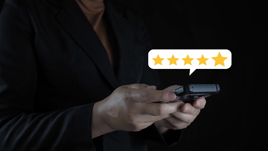 Businessman using tablet with popup five-star icon for feedback review satisfaction service, Customer service experience and business satisfaction survey. Good product and service, best quality