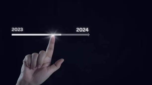 Photo of Businessman touch on virtual bar status to change from 2023 to 2024, countdown of merry Christmas and happy new year by technology concept, start new business and new life. New year's start-up.