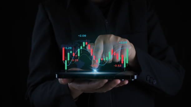 istock Businessman with mobile stock trading graph ,hands using mobile phone. 1909748490