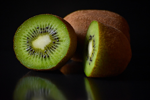 A fresh kiwi fruit placed on top of a table, kiwi fruit isolated image