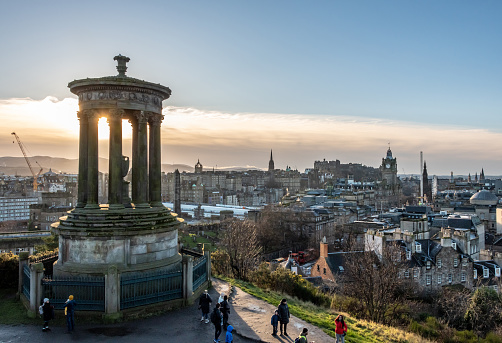 Edinburgh, UK. 26 December 2023. Tourists around the Dugald Stewart Monument overlooking Edinburgh with sunset