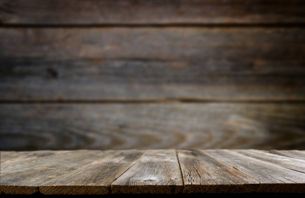 istock Empty rustic wooden table background. Old wood table with dark blurred background. Mock up. 1909822256