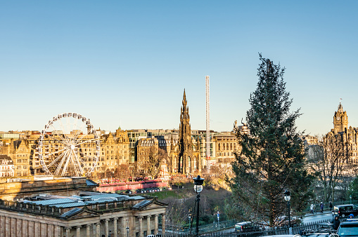 Edinburgh, UK. 26 December 2023. View over Edinburgh Christmas market and fairground rides with winter sun