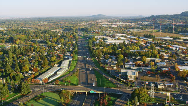 AERIAL Above a highway running through a city in Oregon, USA