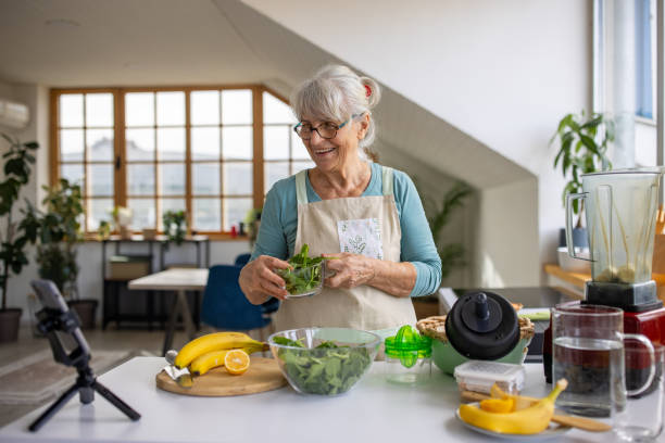 istock Old woman preparing healthy salad for her vlog 1909832738